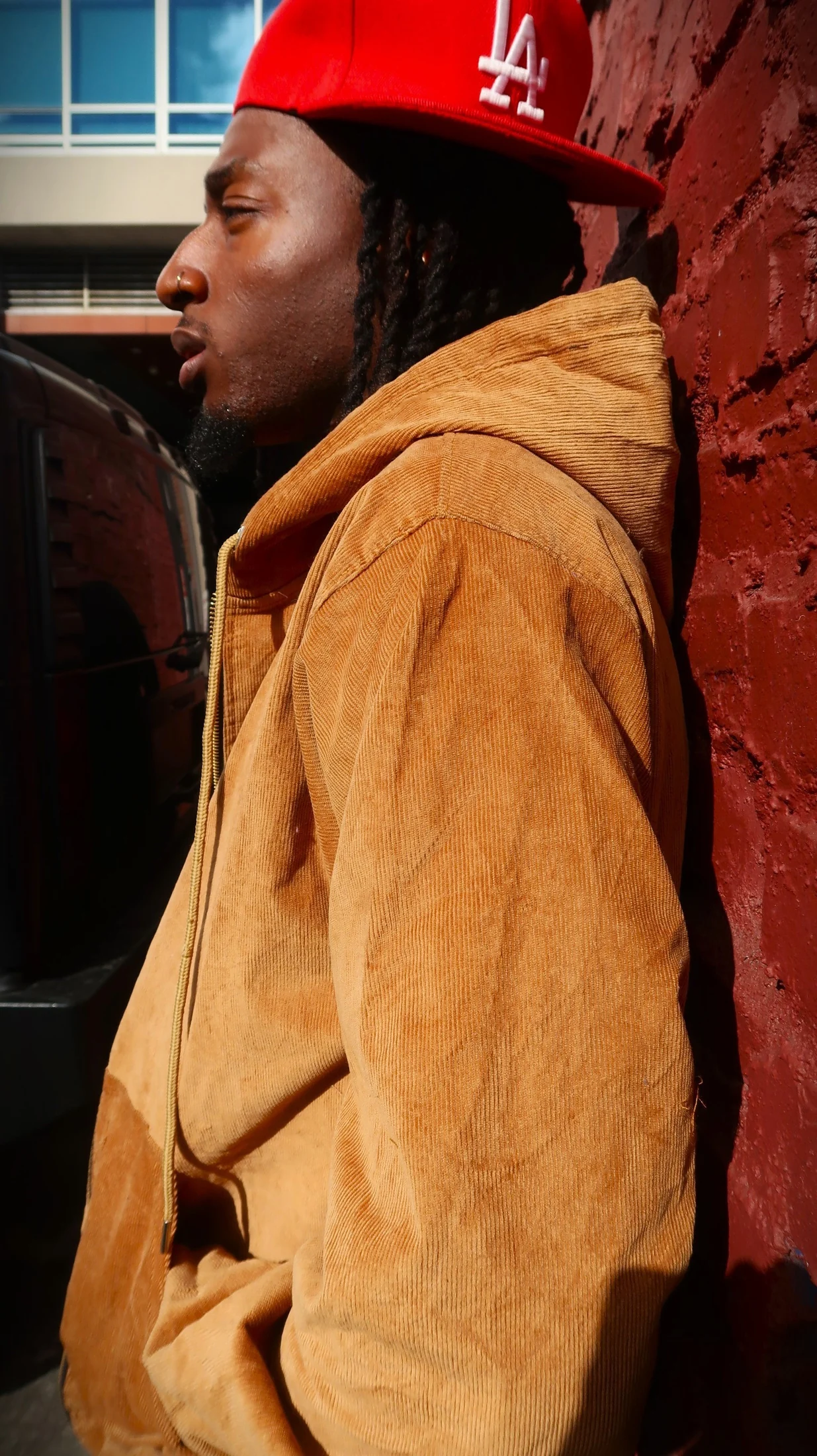 Street editorial profile by red wall