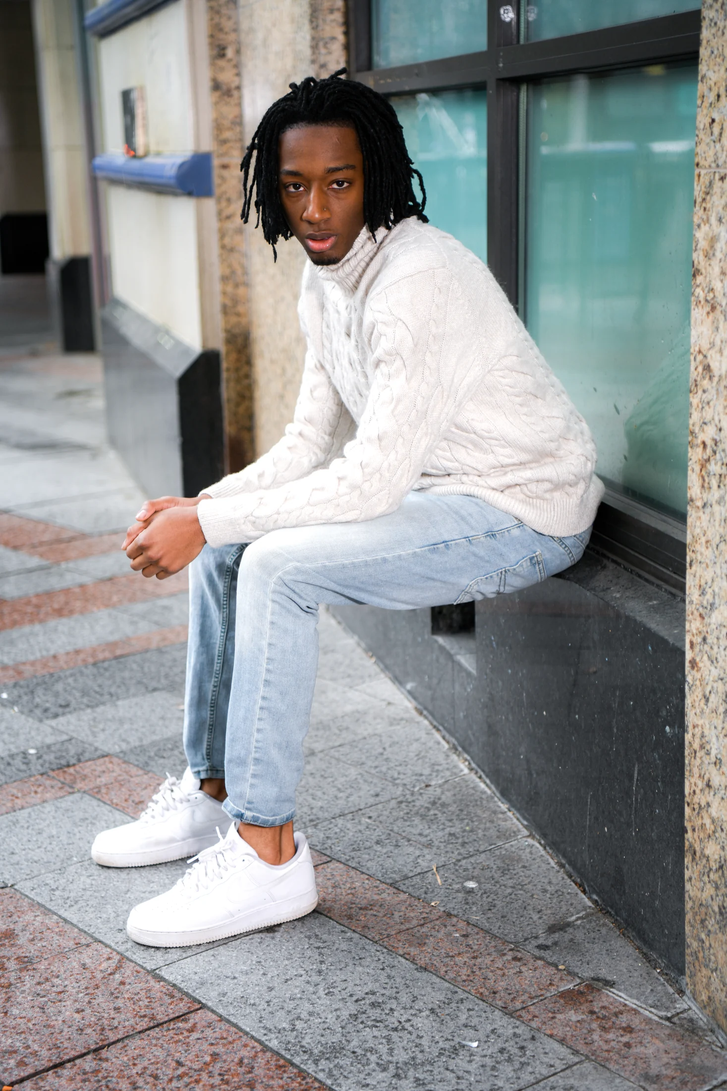 White knit seated menswear portrait